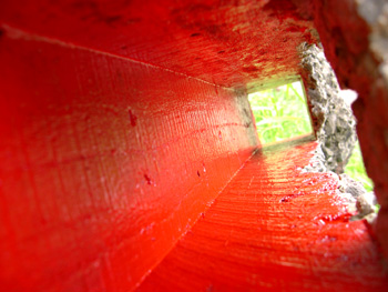 close up of red void painted inside concrete form