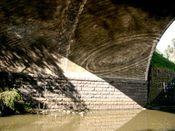 ripples reflected by mirror under bridge
